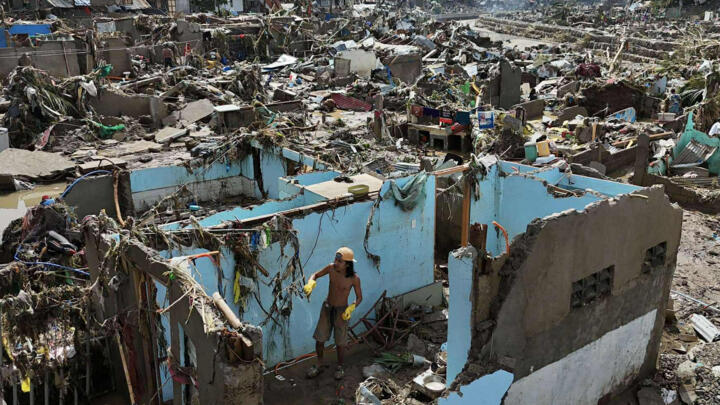 A resident returns to what remains of their home after Typhoon Kalmaegi devastated communities in Talisay City, Cebu province, central Philippines on November 5, 2025.