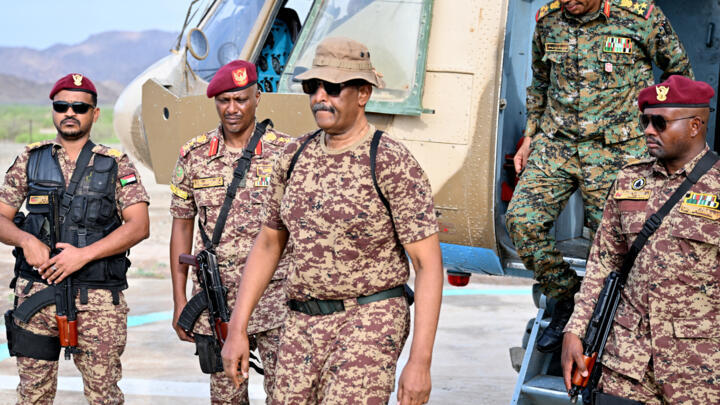 Sudan's army chief Abdel Fattah al-Burhan (C) arrives at a graduation ceremony in Gibet near Port Sudan on July 31, 2024.