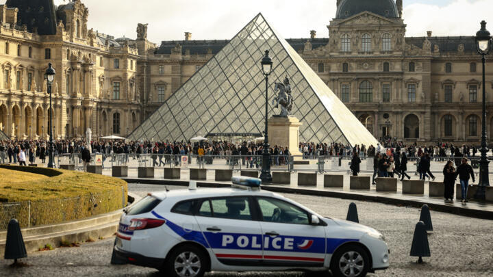 A police car parks in the courtyard of the Louvre museum, one week after the robbery, on Oct. 26, 2025, in Paris.