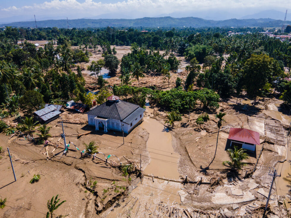 Mud surrounds a mosque in a flood-affected area in Meureudu, in Indonesia's Aceh province