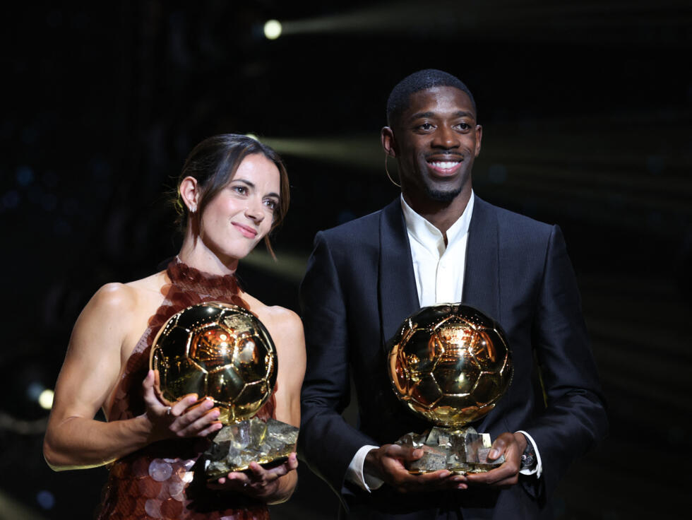 Paris Saint-Germain's French striker Ousmane Dembélé and FC Barcelona's Spanish midfielder Aitana Bonmatí, winners of the 2024 Ballon d'Or, pose after receiving their trophies.