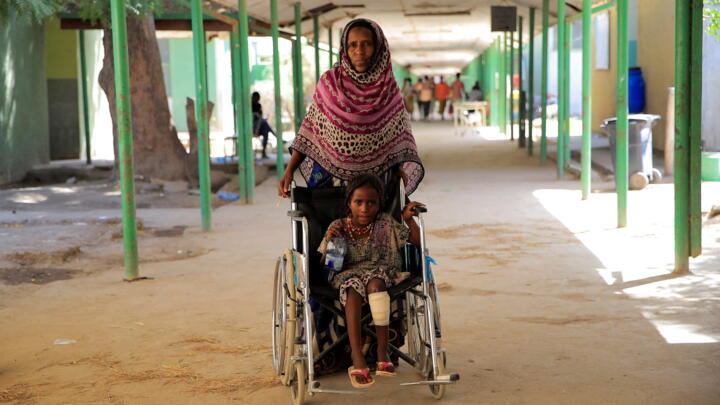 Fatuma Hussein, 40, brings her granddaughter, Fatuma Abdi, 7, for treatment after her left leg was injured by explosives, at the Dubti Referral Hospital, Dubti town, Afar region, Ethiopia, February 24, 2022.