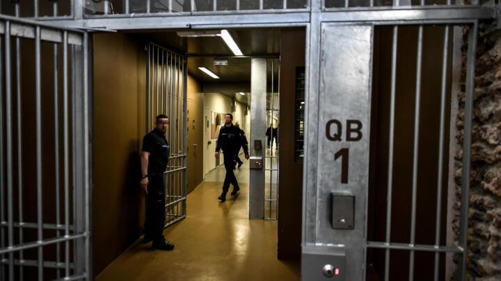 Prison guards stand in a corridor of the Sante prison in Paris.