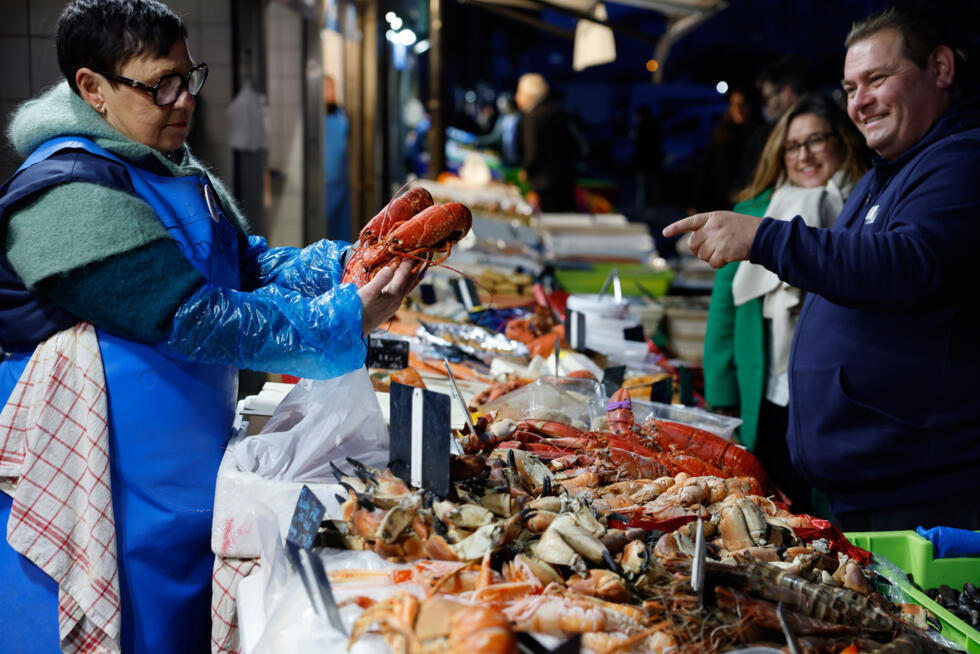 A vendor sells lobsters for a traditional Christmas Eve dinner in the port of Boulogne-sur-Mer, northern France.