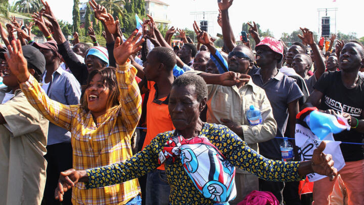 Supporters of Tanzania's main opposition party Chadema, sing and dance during their first political rally after an imposed ban in 2016 was lifted, at Furahisha Grounds in Mwanza, on January 21, 2023.