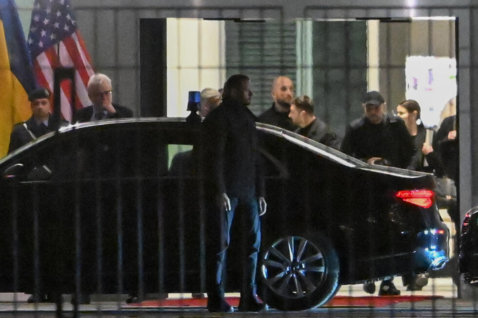 Ukrainian President Volodymyr Zelensky gets into a car after more than five hours of talks at the chancellery in Berlin