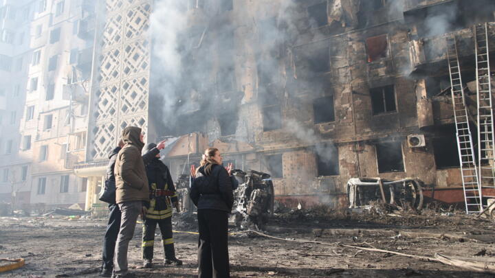 People look at a residential building which was heavily damaged after a Russian strike on Ternopil, Ukraine, on Wednesday, Nov. 19, 2025. 