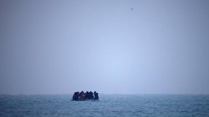 Migrants on an inflatable dinghy leave the coast of northern France to cross the English Channel, near Wimereux, France, November 24, 2021.
