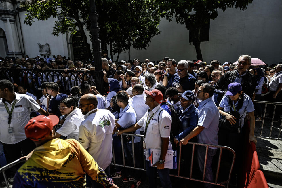 People line up during the Bolivarian militia enlistment process at Bolivar Square in Caracas