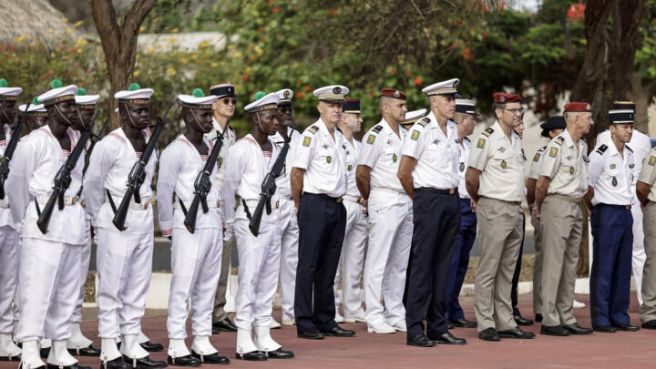 French army staff (R) and Senegalese army staff (L) arrive ahead of a ceremony where France will return Camp Geille, its largest base in the country, and its airfield at Dakar airport.
