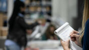 An observer takes notes as they watch Gwinnett County workers continue to process absentee and provisional ballots at the Gwinnett Voter Registrations and Elections office on November 6, 2020 in Lawrenceville, Georgia, USA.