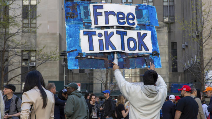 File photo: A man carries a Free TikTok sign in front of the courthouse where the hush-money trial of Donald Trump was underway on April 15, 2024, in New York.