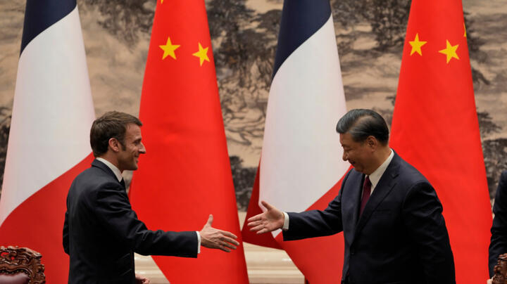 FILE - French President Emmanuel Macron, left, shakes hands with Chinese President Xi Jinping after meeting the press at the Great Hall of the People in Beijing on April 6, 2023.