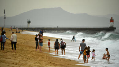 Warm October weather has seen many flock to the beach -- such as here at Hossegor, southwestern France -- but environmentalists see more evidence of climate change