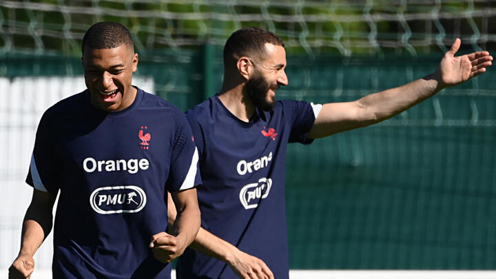 France forwards Kylian Mbappé (L) and Karim Benzema during a training session at the team's training grounds in Clairefontaine-en-Yvelines, southwest of Paris, on June 13, 2021.