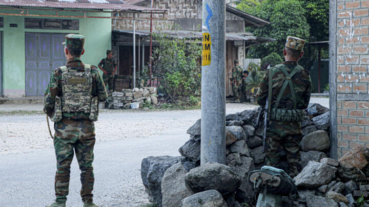 Fighters of the ethnic armed group Ta'ang National Liberation Army stand guard in the town of Namhkam in northern Shan state on November 9, 2023. 