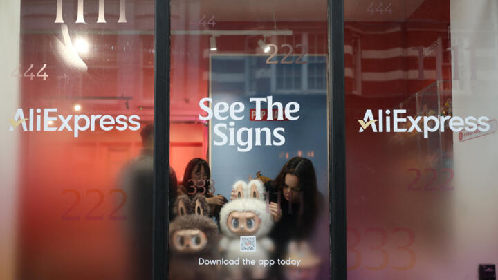 A staff member arranges some POP MART LABUBU THE MONSTERS dolls on a window shop ahead of an AliExpress livestream shopping show at a pop-up store in London, Britain on November 11, 2025. 