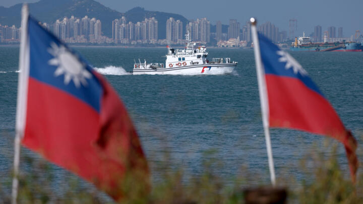A Taiwan Coast Guard ship patrols near Dadan Island, with the Chinese city of Xiamen visible in the background, on Dadan Island, Kinmen, Taiwan, on October 18, 2025.