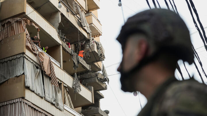 People inspect a damaged building, after Israeli military said on Sunday that it struck a militant from the Lebanese Iran-aligned Hezbollah group, in Beirut's southern suburbs, Lebanon November 23, 2025.