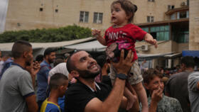 Palestinians in Gaza celebrate following the announcement that Israel and Hamas have agreed to the first phase of a peace plan on October 9, 2025.