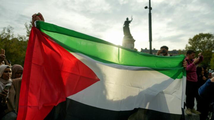 A protester holds up a Palestinian flag at an unauthorised rally in solidarity with Gaza held in central Paris on October 12, 2023.