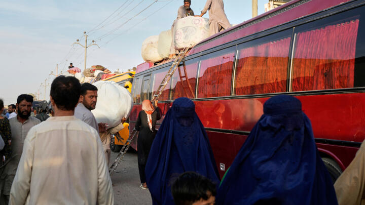 Afghan refugees board a bus to leave for their homeland Afghanistan, at a terminal in Karachi, Pakistan, April 9, 2025.