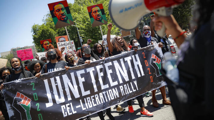 FILE- In this June 19, 2020, file photo, protesters chant as they march after a Juneteenth rally at the Brooklyn Museum, in the Brooklyn borough of New York.