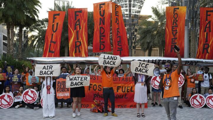 Activists protest against fossil fuels at the COP28 UN Climate Summit on Tuesday, December 5, 2023, in Dubai, United Arab Emirates.