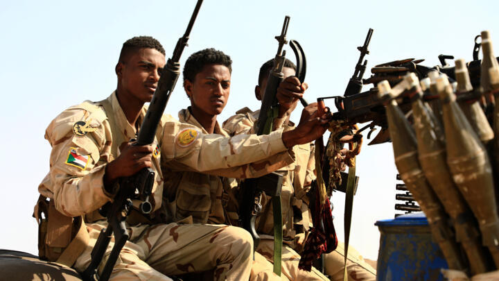 In this file photo, Sudanese soldiers from the Rapid Support Forces unit patrol during a rally for Dagalo, in Garawee town, north of Sudan on June 15, 2019