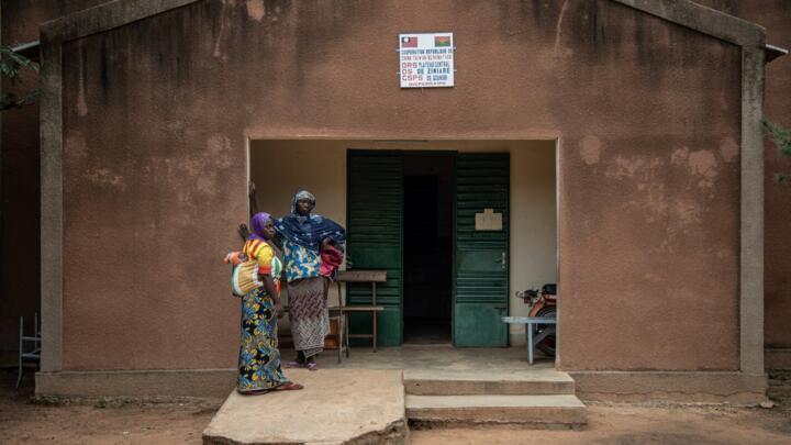 Women stand outside a village health centre northeast of Burkina Faso's capital Ouagadougou.