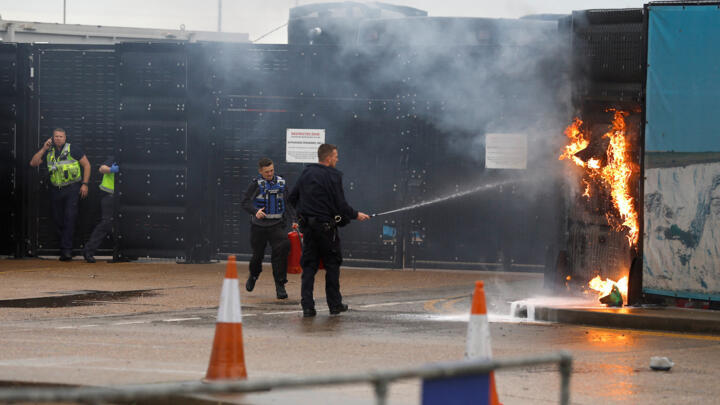 Members of the military and UK Border Force extinguish a fire from a petrol bomb targeting the Border Force centre in Dover, Britain, October 30, 2022.