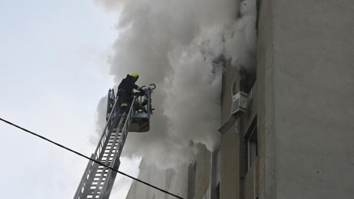 Firefighters extinguish a fire in a residential building following a Russian drone strike in Kharkiv on July 7, 2025.
