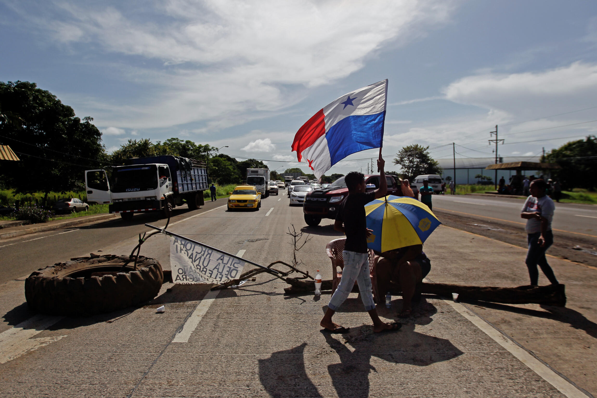 Un manifestante porta una bandera panameña durante un bloqueo en la vía Panamericana en Aguadulce, a 200 km al suroeste de Ciudad de Panamá, el 15 de julio de 2022