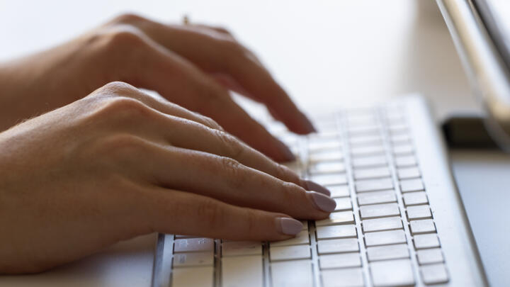 A person types on a keyboard in Portland, Oregon, US on June 6, 2024.