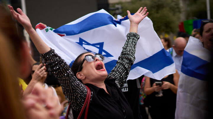 People celebrate following the announcement that Israel and Hamas have agreed to a peace plan in Tel Aviv, Israel, Thursday, Oct. 9, 2025.