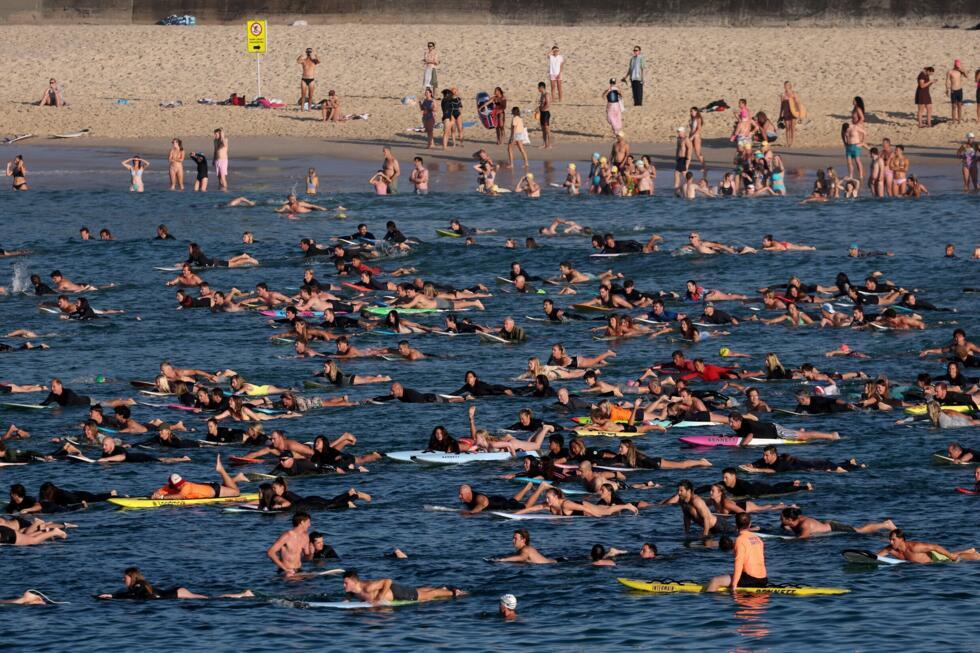 Surfers and swimmers paddled out at Bondi Beach in memory of the shooting victims
