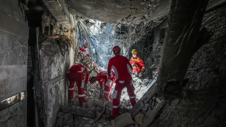 Rescuers sift through the rubble inside in the Evin prison complex in Tehran after it was hit by an Israeli airstrike on  June 25, 2025.