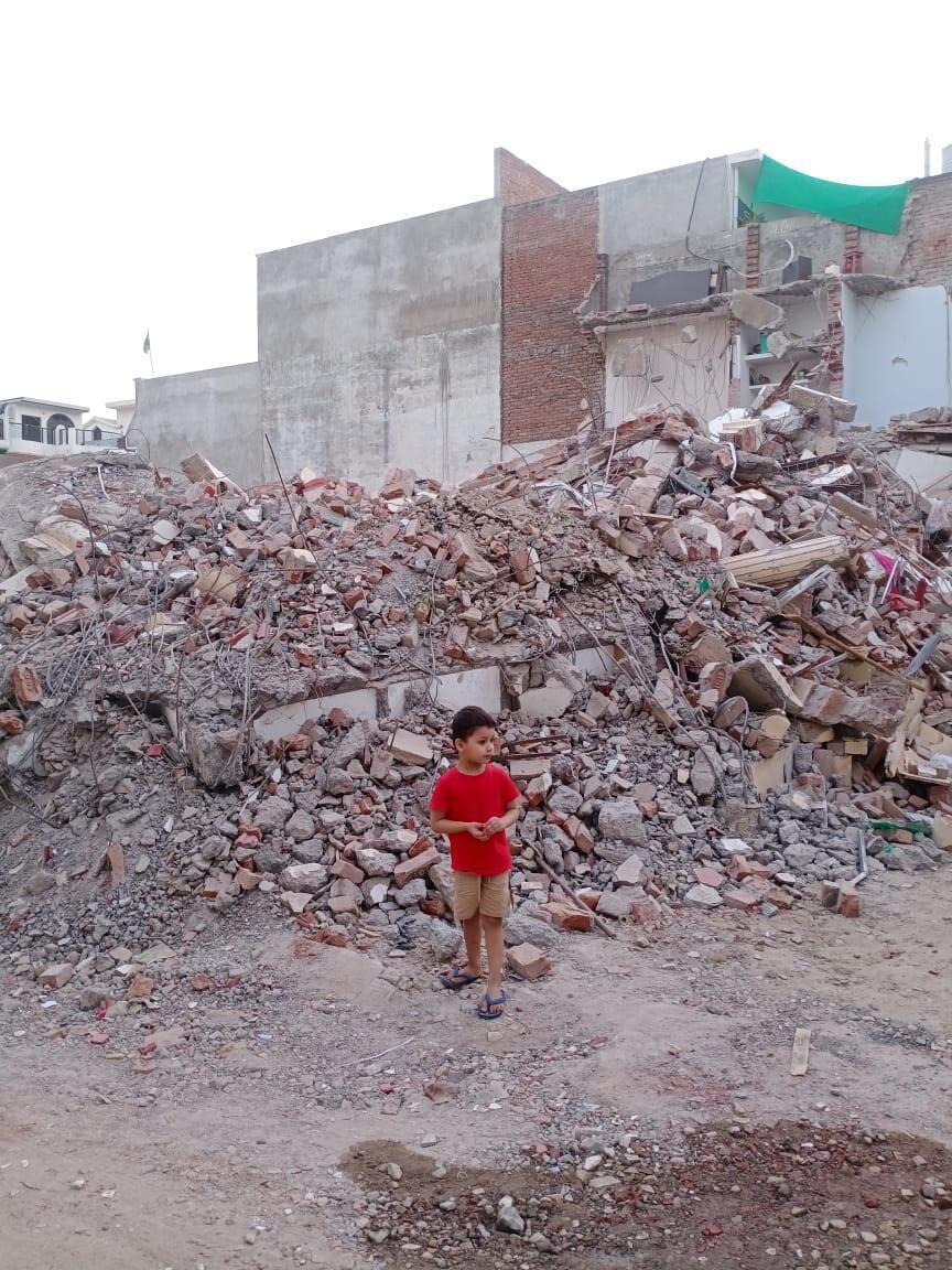 Mohammad Umam's son, Hassan, 4, at the site of the family's destroyed home on June 14, 2022.