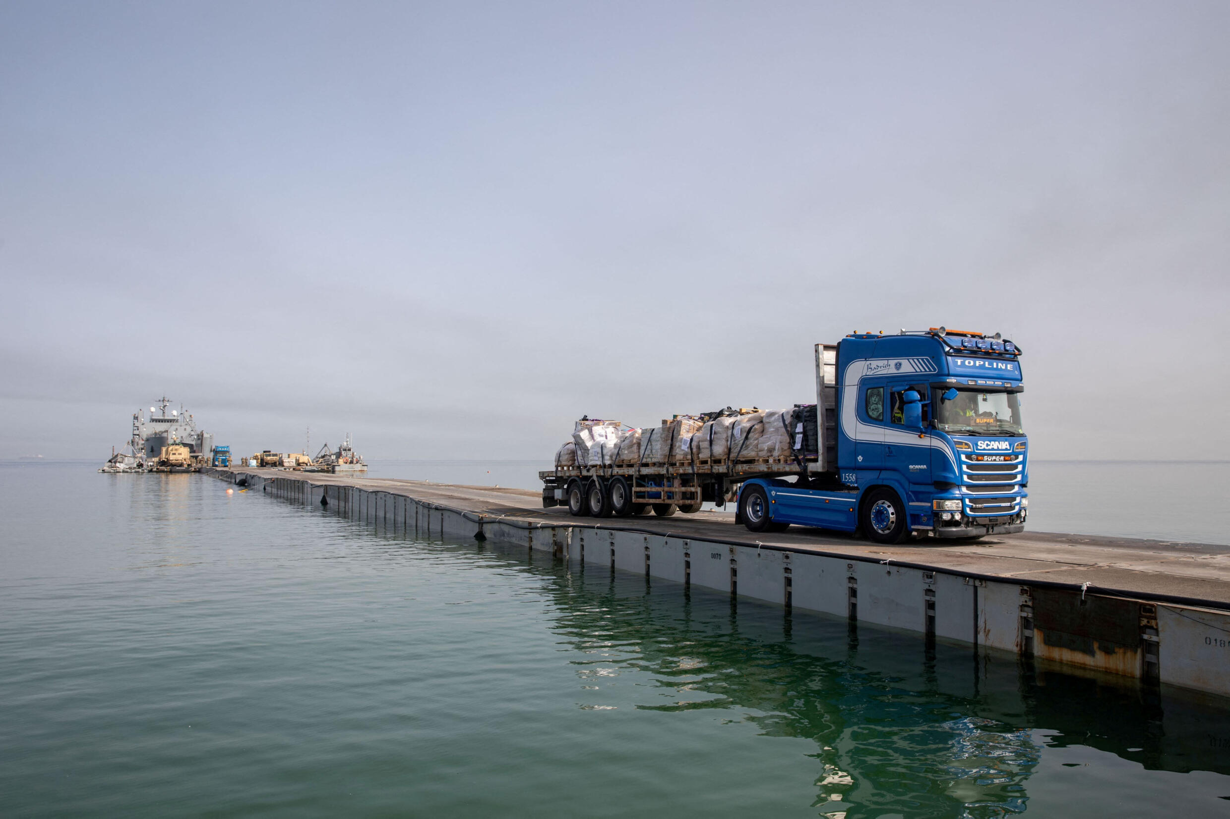 Un camión transporta ayuda humanitaria a través de Trident Pier, un muelle temporal para entregar ayuda, frente a la Franja de Gaza, en medio del actual conflicto entre Israel y el grupo islamista palestino Hamás, cerca de la costa de Gaza, 19 de mayo de 2024.
