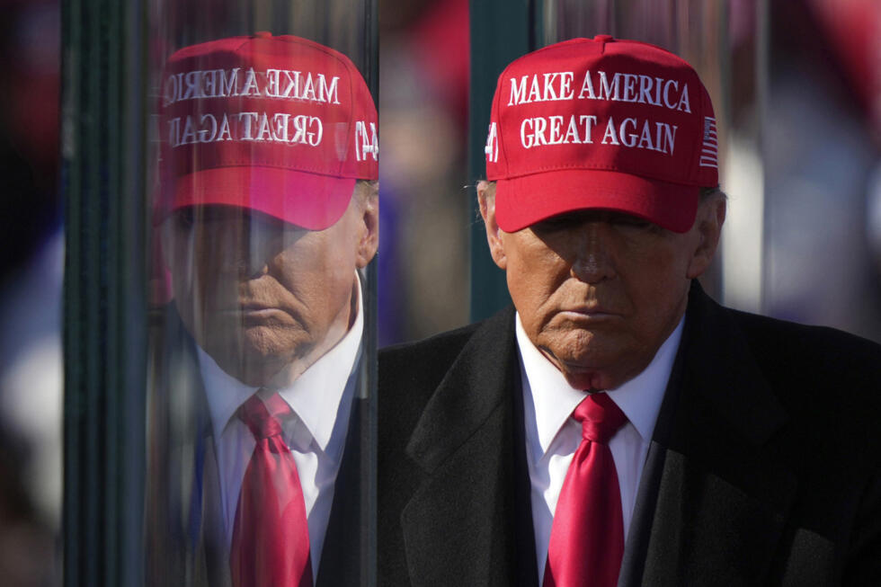 [File photo] Republican presidential nominee former President Donald Trump is reflected the bullet proof glass at a campaign rally in Pennsylvania on November 3, 2024.