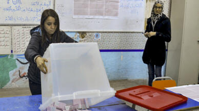 An ISIE agent begins counting ballots at a polling station in Tunis on December 17, 2022 during the parliamentary election.