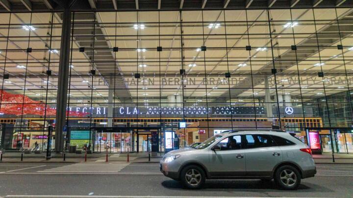 A car sits outside Berlin Brandenburg Airport after it was closed earlier in the evening due to a drone sighting on October 31, 2025, in Schenefeld, Germany.