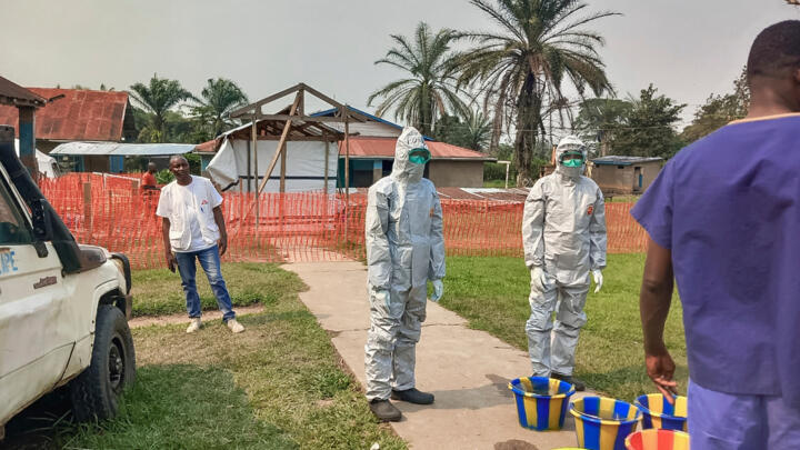 Men stand outside an Ebola treatment center in the remote Bulape Health Zone, Kasai province, the Democratic Republic of Congo, Sunday, September 7, 2025.