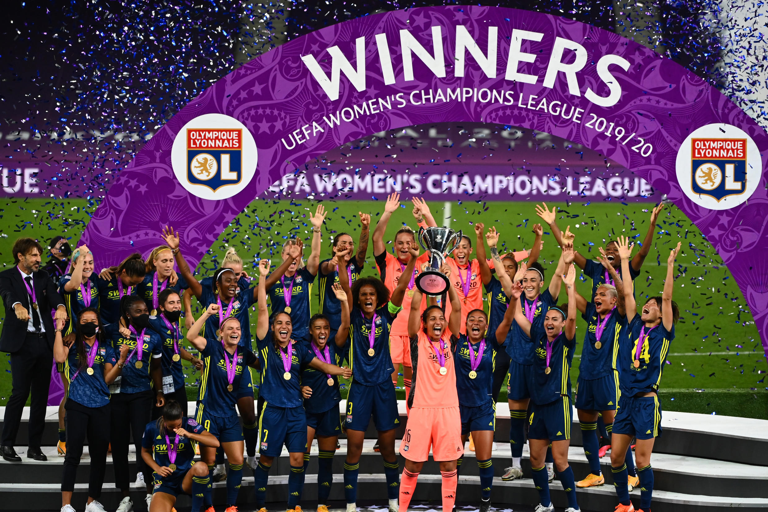 Lyon's players celebrate after defeating Wolfsburg in the Champions League final on August 30.