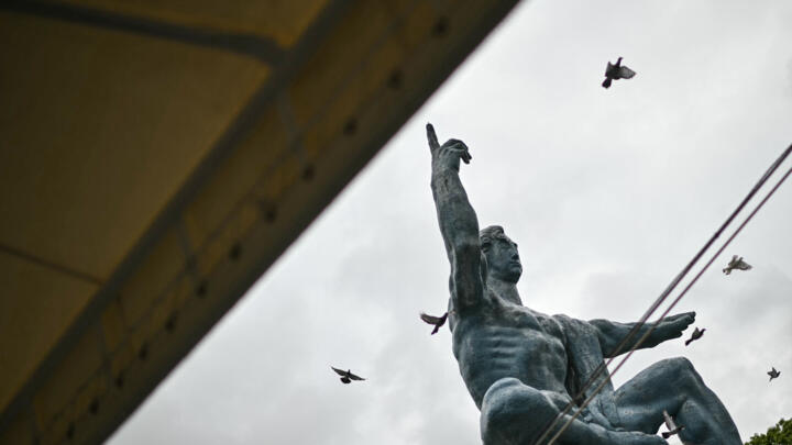 Doves fly past the "Peace Statue" after being released into the air during the annual memorial ceremony at the Peace Park in Nagasaki on August 9, 2025