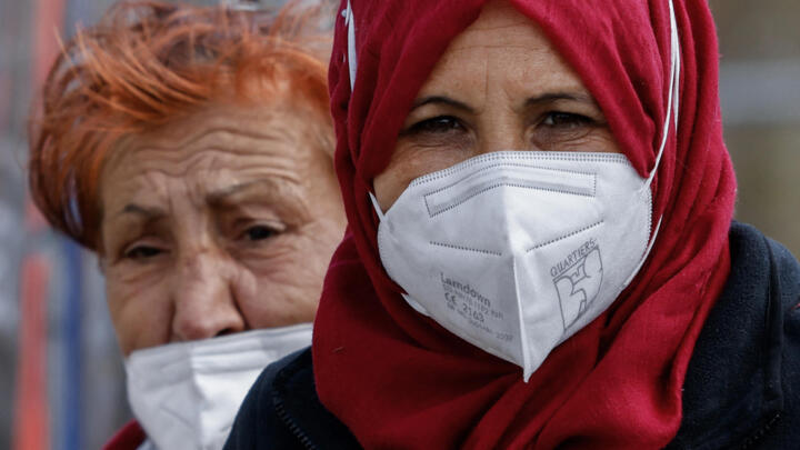 Two women wearing face masks are seen on April 2, 2021 in Berlin's Kreuzberg district, amid the ongoing coronavirus (Covid-19) pandemic.