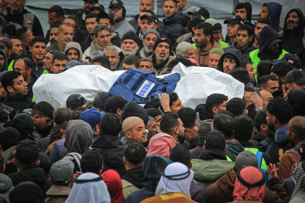 Family members and colleagues carry the body of one of three Palestinian journalists killed in an Israeli strike, during a funeral procession in Khan Younis, in the southern Gaza Strip, on January 22.