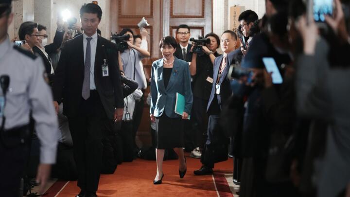 Sanae Takaichi walks before signing a policy agreement in Tokyo on October 20, 2025.
