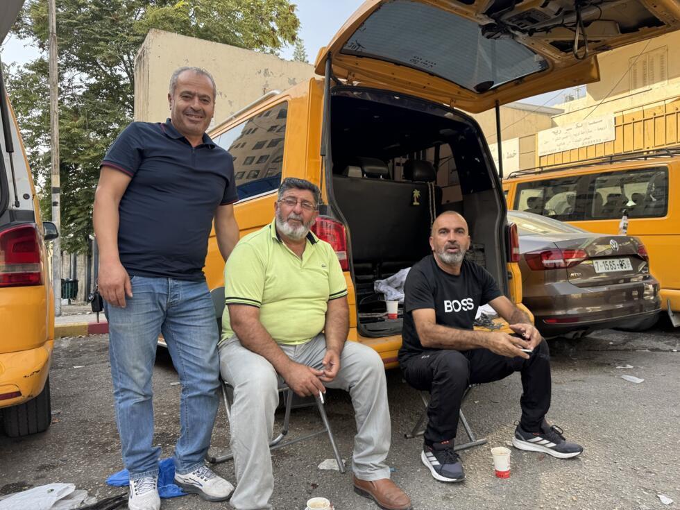 Hatim Ali Hassan (left) together with his shared-taxi driver colleagues at a bus station in Nablus, in the West Bank.