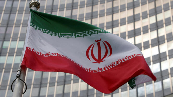 A file photo showing the Iranian flag in front of the International Atomic Energy Agency (IAEA) organisation's headquarters in Vienna, Austria, June 5, 2023.